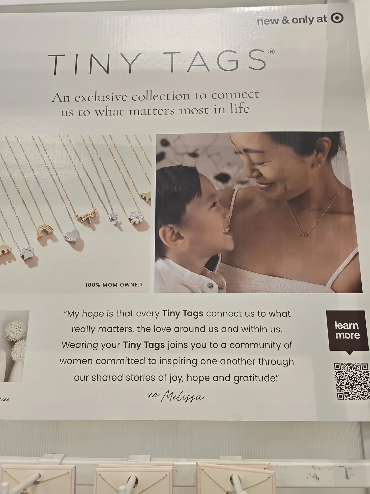 Tiny Tags 品牌海报,标 new and only at Target、100% MOM OWNED,母亲与孩子额头相抵照片,创始人 Melissa Clayton 的一段话与签名