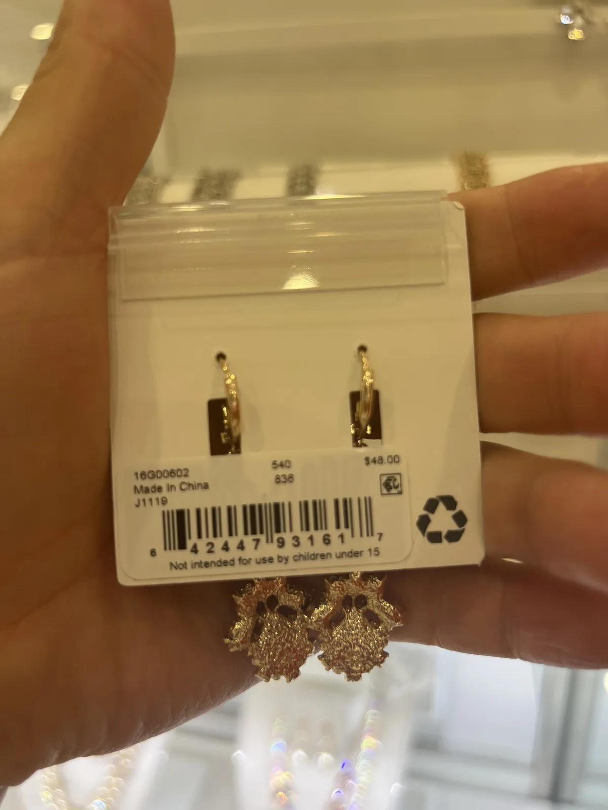 手持时尚饰品价签,背面印 Made in China,标价 48.00 美元